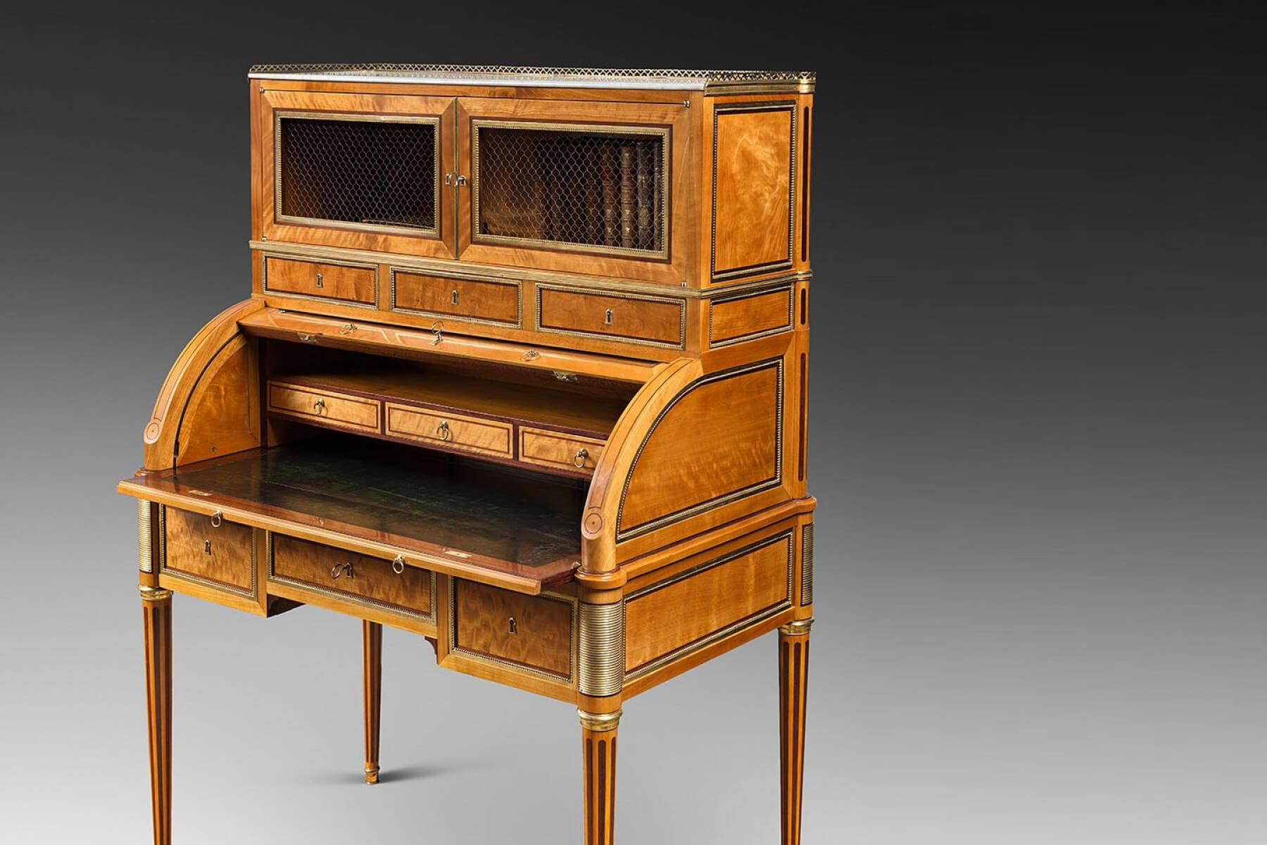 A rare Louis XVI ormolu-mounted lime wood and amaranth bureau cylindre by G.Dester