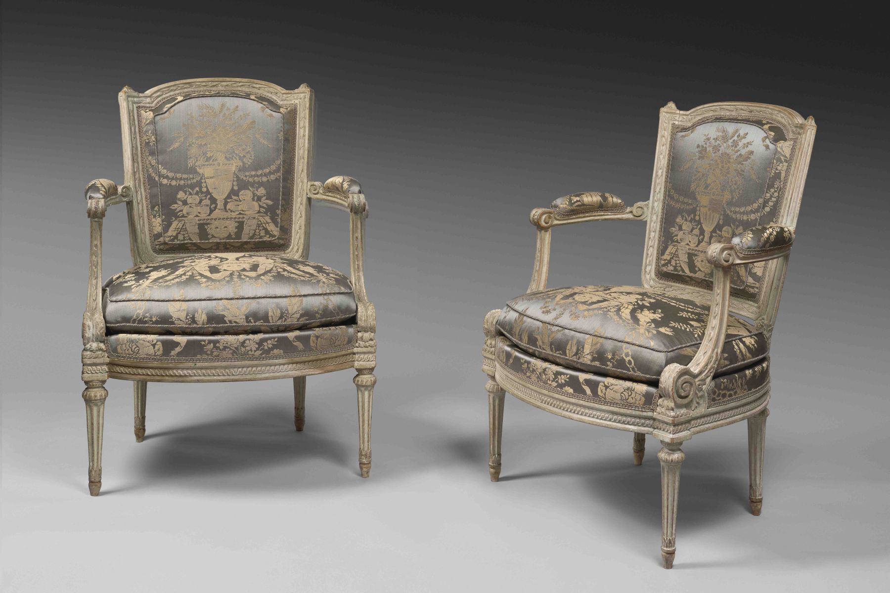 A louis XVI laquered wood pair of armchairs