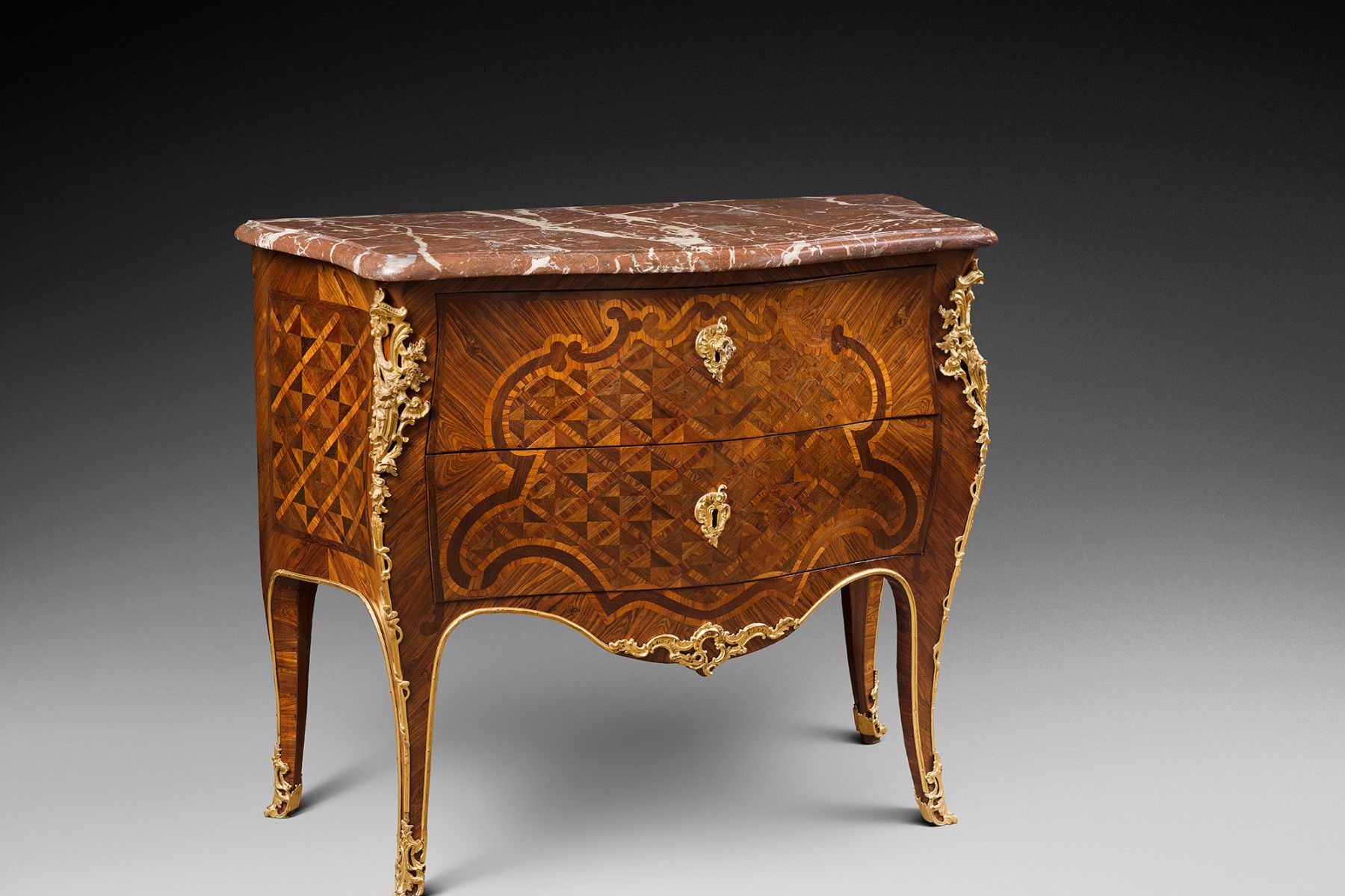 A Louis XV ormolu-mounted kingwood, tulipwood and marquetry commode